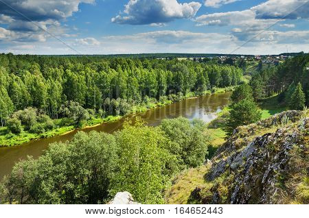 A beautiful rural landscape. Russia. Ural. In the distance the village of Kamenka