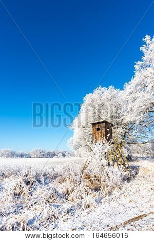 Wooden Brown Hunting Hideout Next To Frozen Trees