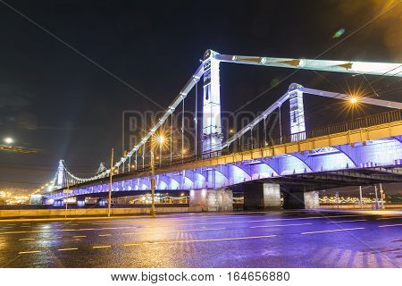 Krymsky Bridge at night, steel suspension bridge in Moscow, Russia. The bridge spans the Moskva River