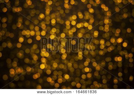 Abstract backgroung of golden glitter and glow soft bokeh shining light. Dreamy sparkle background