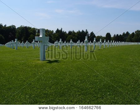 Rows of crosses in Hamm Cemetery in Luxembourg City on a sunny summer day mark the graves of fallen American Soldiers in World War II.
