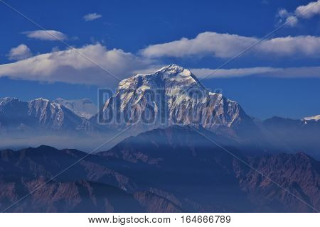Mount Dhaulagiri seen from Gorepani. Seventh highest mountain in the world. Cloudy day and layers of smoke.