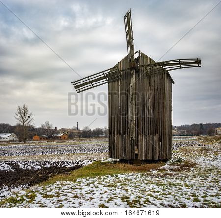 Late autumnal landscape with an ancient wooden windmill in Dikanka village Ukraine