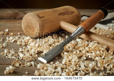 woodworking tolls chisels and mallet on a workbench