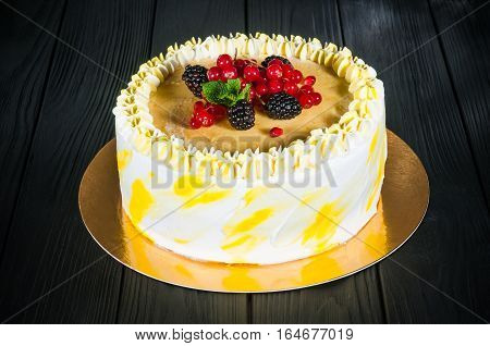 Delicious cake on a wooden black background