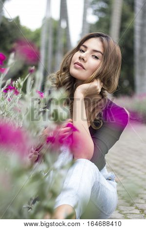 Portrait of a beautiful woman behind some flowers