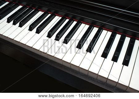 Black and white piano keys diagonal view
