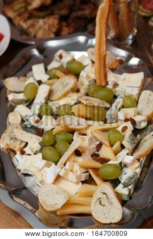assorted apetizer in a metal pan shot with artificial light