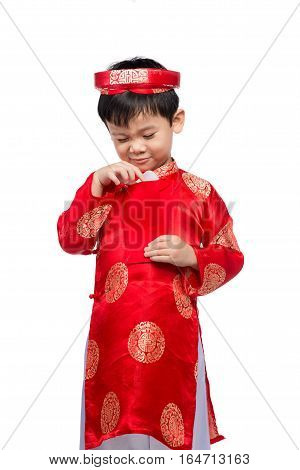 Little Vietnamese boy holding red envelops for Tet. The word mean double happiness. It is the gift in lunar new year or Tet Holiday on red isolate background.
