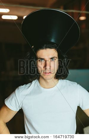 Portrait of a young man in a strange unusual hat