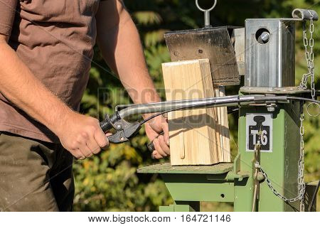 Man is using a electric log splitter