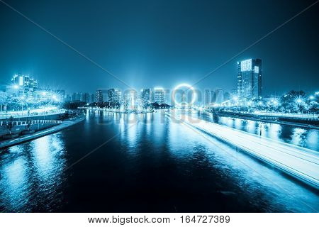 night scene of haihe river and ferris wheel in tianjin blue tone