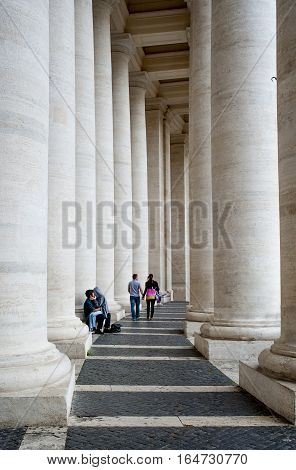 Rome Italy - May 16052015: Enamoured pair between the colonnades at the entrance to the Vatican on St.Pitera square.