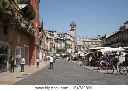 Verona Italy - May 18 2015: Erbe Square - the most ancient area of Verona. The Maffei palace is a background of the area. In the afternoon on the square trade in greens.