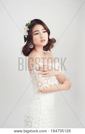Beautiful asian woman bride on grey background