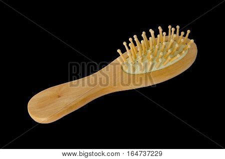 Comb. Wooden combon isolated on black background.Clipping path