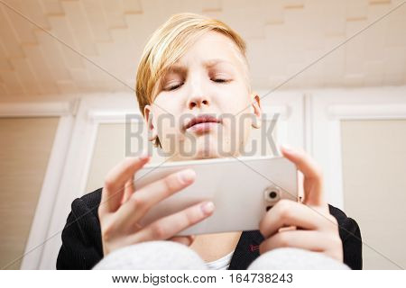 Teenager with phone in hands. Internet dependence computer games