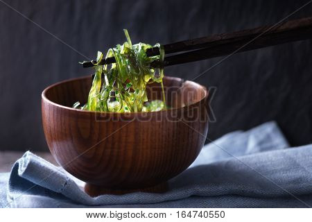 Chinese chopsticks with chuka salad horizontal background
