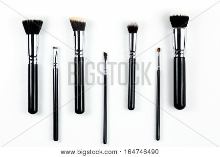 Makeup brushes lying on a white background