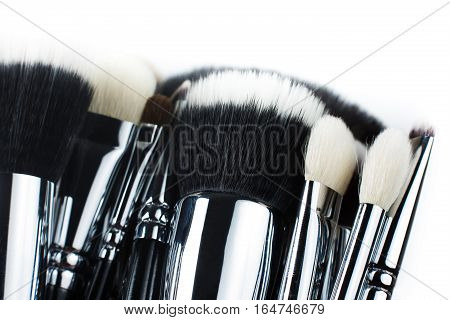 Makeup brushes lying on a white background