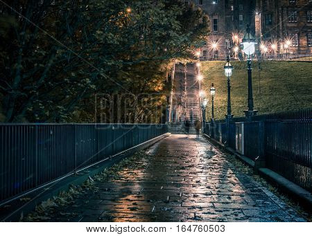 Narrow dark street with ghosts walking by