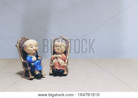 Still Life Photography With Lovely Grandpa Is Smoking And Grandma With Cat Doll Siting Rocking Bambo