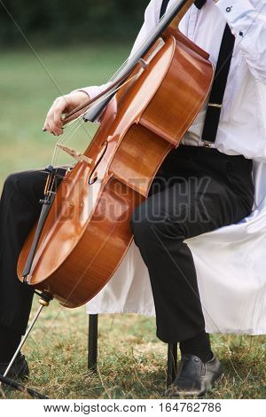 Young Man Playing Cello Outside.