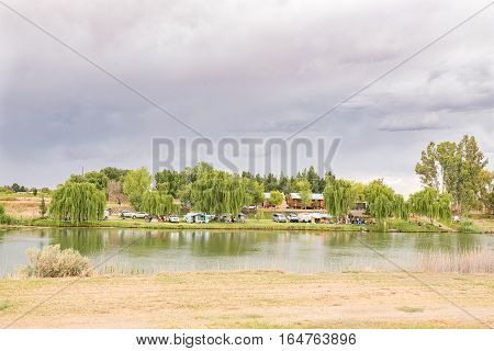 RITCHIE SOUTH AFRICA - DECEMBER 25 2016: Unidentified campers at a caravan park next to the Riet River (reed river) at Ritchie a small town in the Northern Cape Province