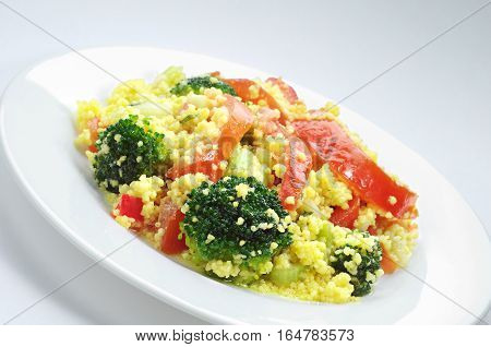 Kuskus salad with vegetables in white plate