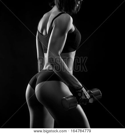 Remember why you started. Female bodybuilder working out lifting weights showing off her toned backside monochrome shot