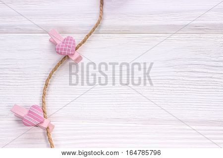 Happy Valentine's Day. Pink hearts with clothespins in a clothes line