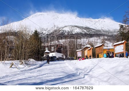 SLOVAKIA STARY SMOKOVEC - JANUARY 06 2015: View of the High Tatras mountains with the peaks covered with snow from center of Stary Smokovec. Is a popular resort in Slovakia for skiing and hiking.