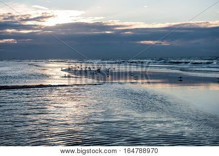 Sunset with reflection on the beach of Koksijde Belgium