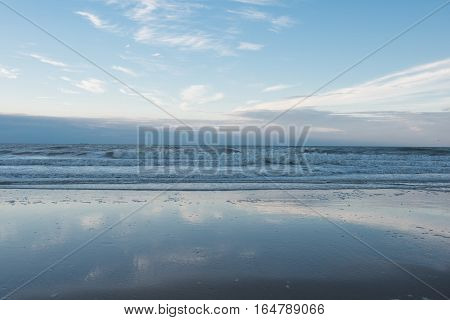 Beach and surf of the North Sea in Koksijde Belgium