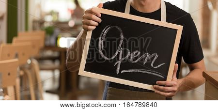 Man Holding A Blackboard