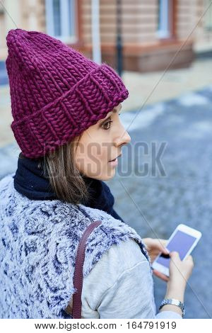 The girl with a smartphone, is walking through the old town