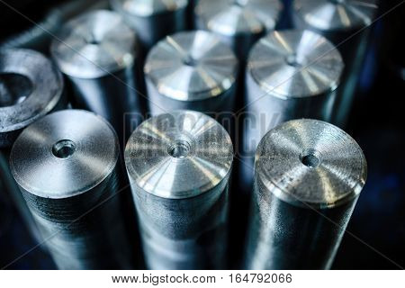 Steel threaded studs. Details made lathe. Shallow depth of field. Abstract industrial background.