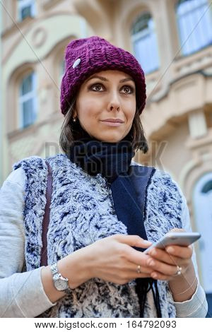 The girl with a smartphone, is walking through the old town