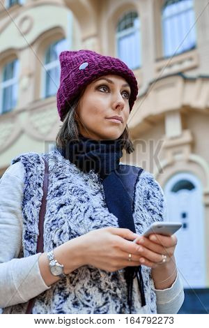 The girl with a smartphone, is walking through the old town