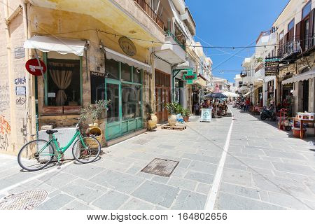Rethymnon, Island Crete, Greece- July 1 2016: The narrow street of Rethymnon (part of Old Town) where there are a lot of small cafes and shops