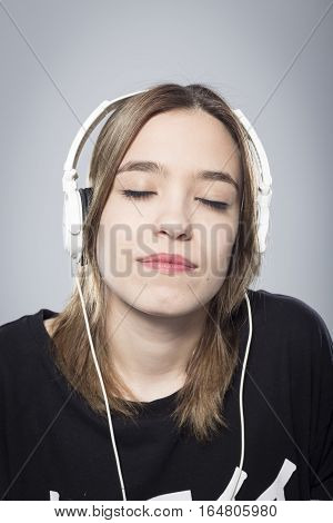 Happy girl listening to music with headphones