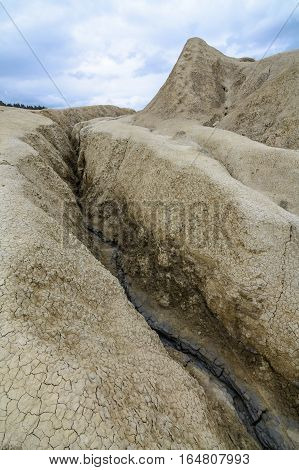 Vertical View With Earth Cracks. Dry Land In Natural Park With Muddy Volcanoes, Dramatic Landscape,
