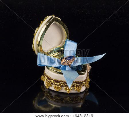 Valentine's sapphire ring box tied with blue ribbon