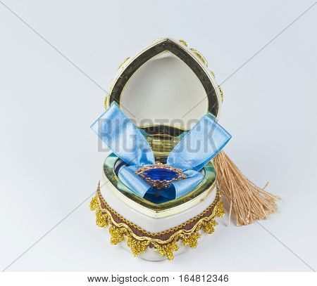 Valentine's sapphire ring box tied with blue ribbon