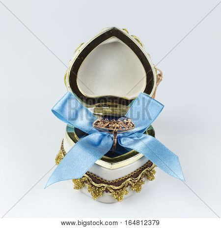 Valentine's sapphire ring box tied with blue ribbon
