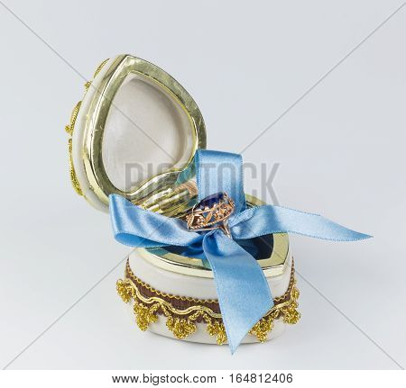 Valentine's sapphire ring box tied with blue ribbon