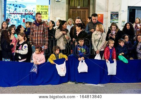 Torrevieja Spain - January 5 2017: Children waiting for a candies in Cavalcade of the Magi parade or The night of the Three Wise Men in downtown of Torrevieja. The Cavalcade of Magi attracts thousands of visitors every year.