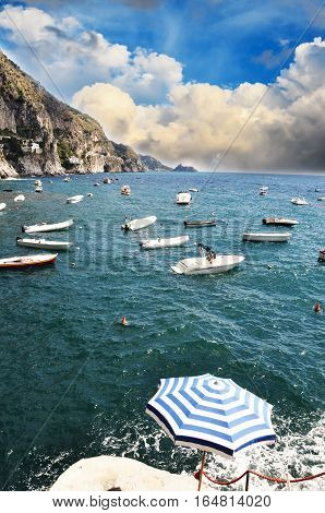 Small vessels sailing along the coast line in Praiano, Amalfi Coast - Italy