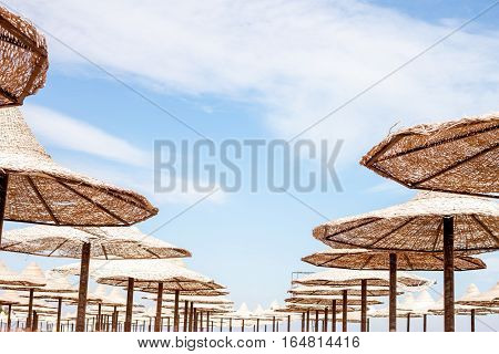 group of straw beach umrellas on the Red sea