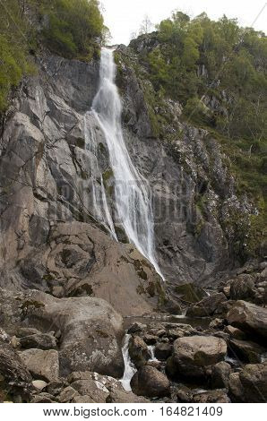 Aberfalls waterfall, rock face, close portrait with trees abergwyngregyn wales